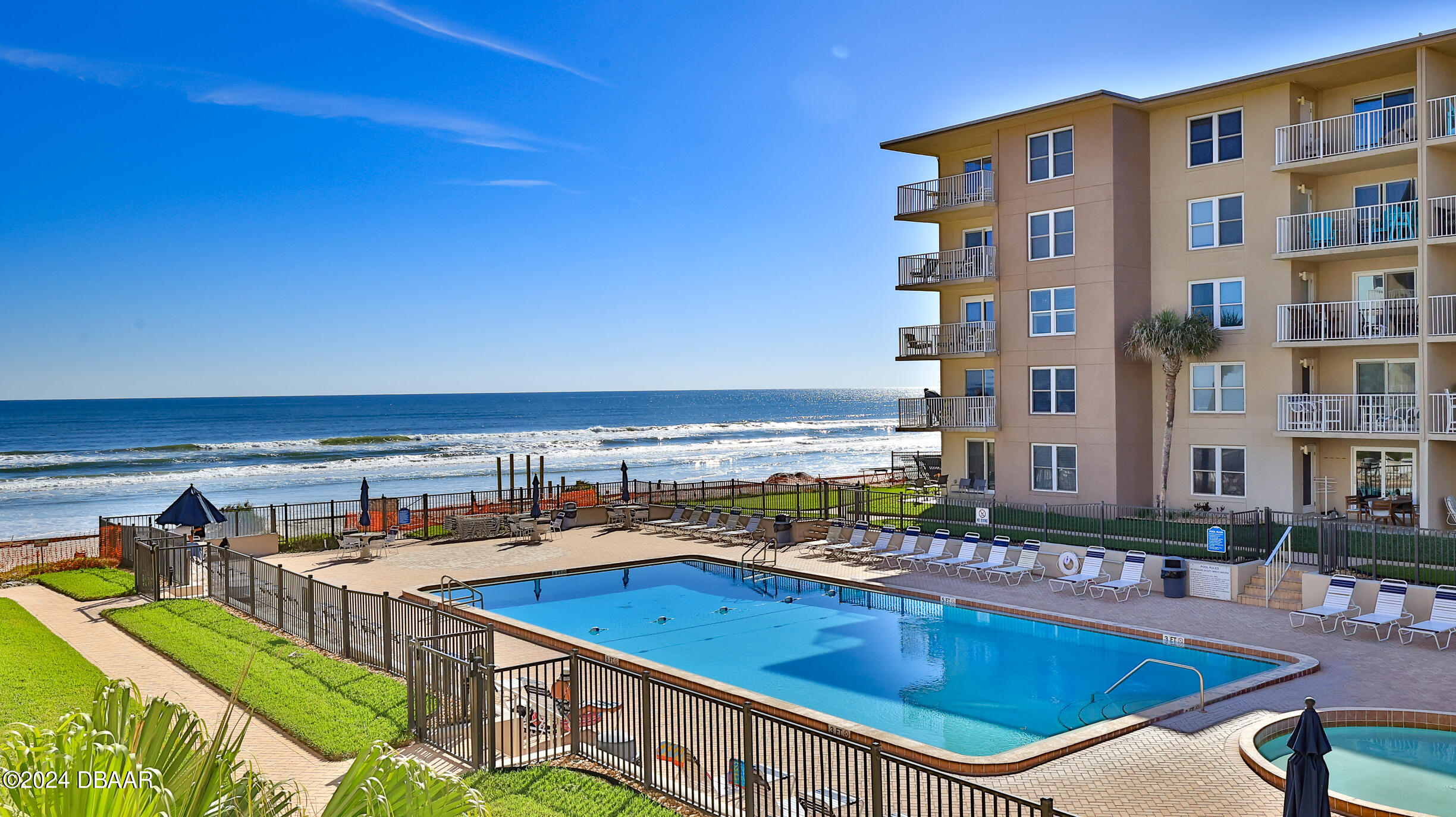 a view of a swimming pool with outdoor seating