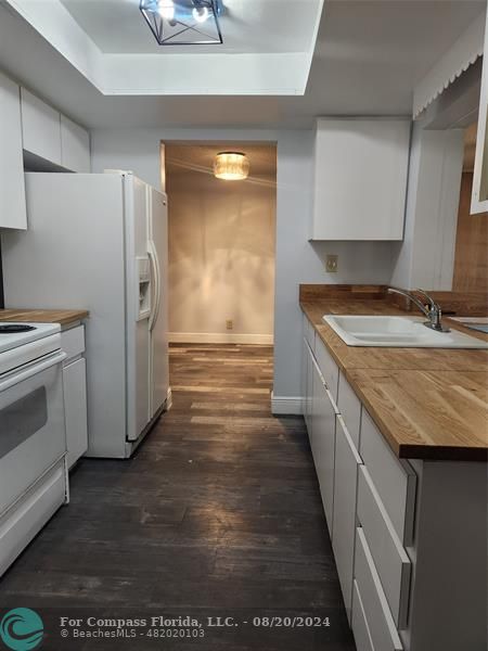 a kitchen with stainless steel appliances granite countertop a sink and a stove top oven