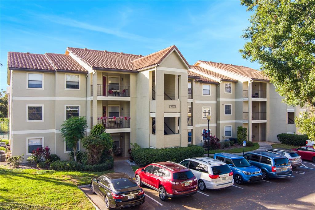 a front view of a house with cars parked