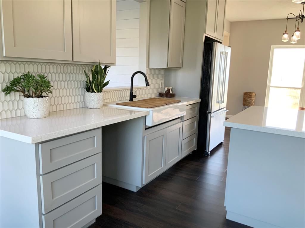 a kitchen with a sink and refrigerator