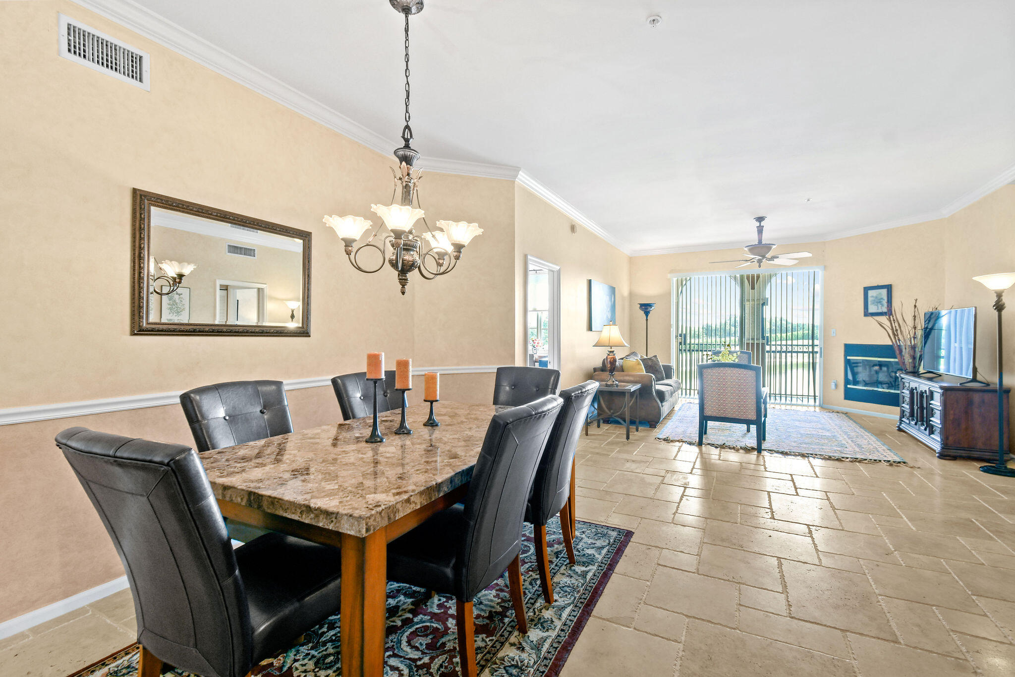 a dining room with furniture a chandelier and window