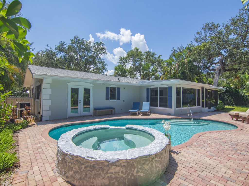 a house with a swimming pool in front of it