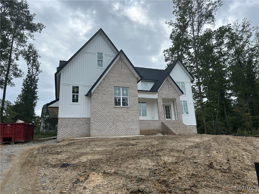 a front view of house with yard and trees around