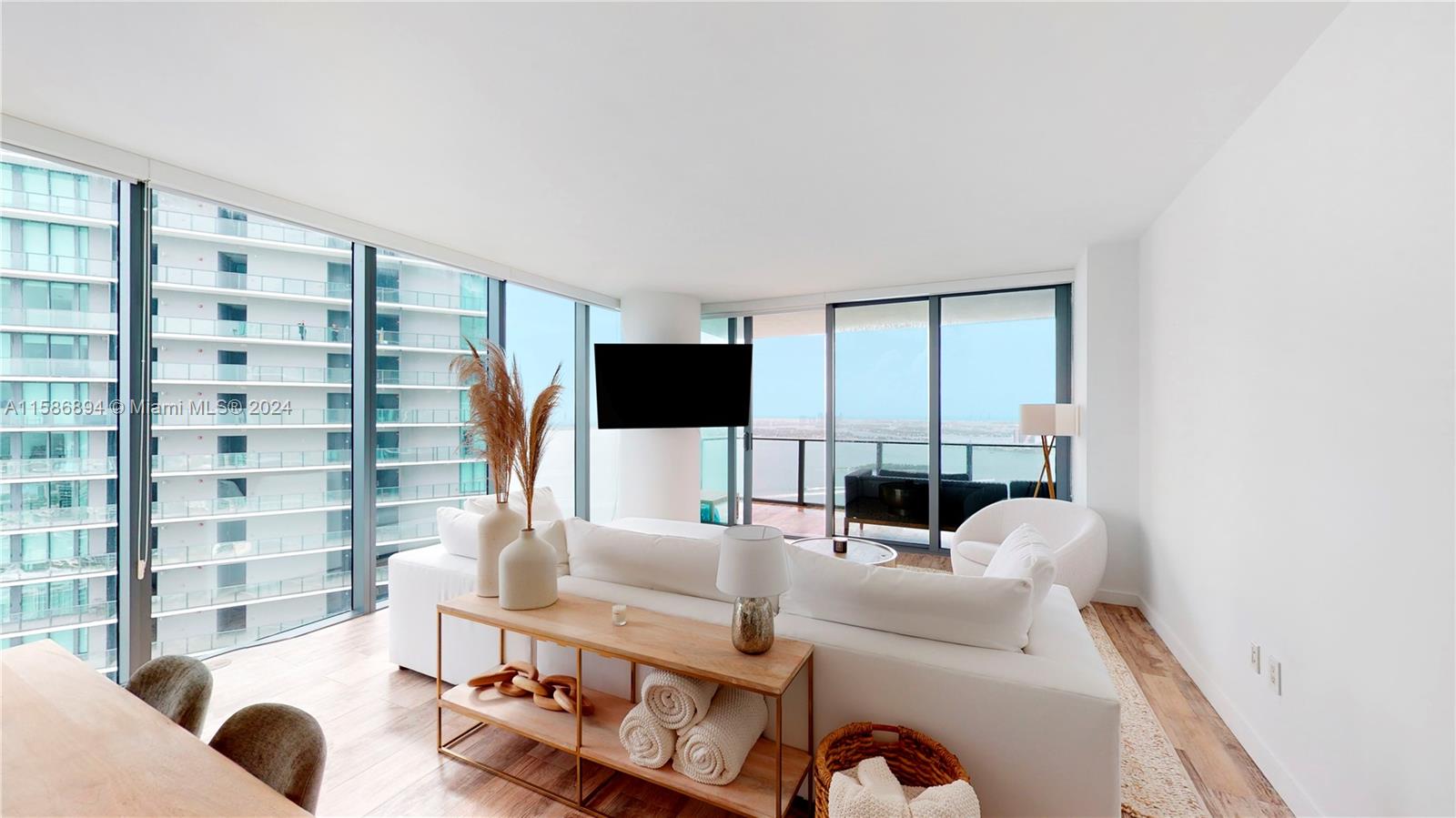 a living room with furniture and a floor to ceiling window