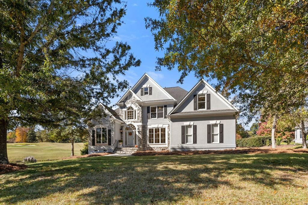 a front view of a house with a garden