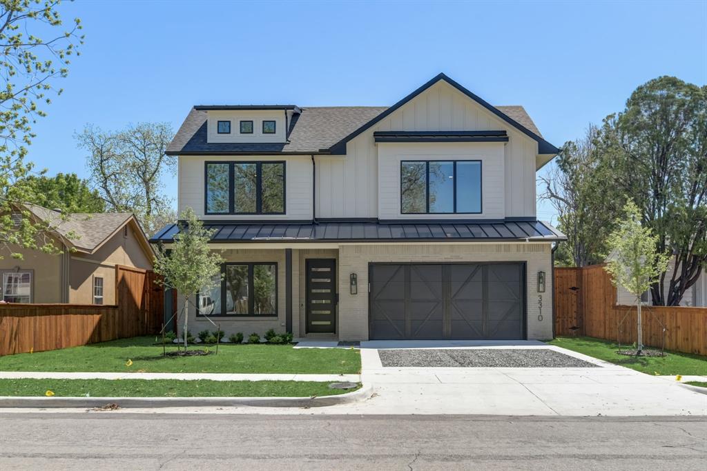 a front view of a house with a garden and garage