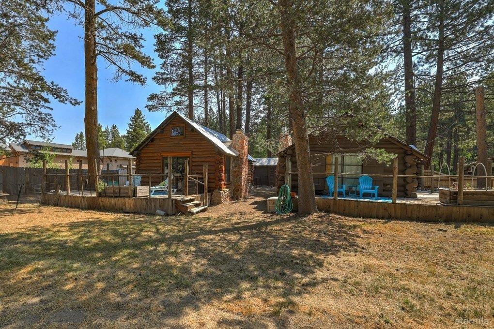 These are the two cabins, viewed from the adjacent meadow.  Since the meadow is unbuildable, current owner keeps the meadow mowed and watered for their enjoyment.  Owner's cabin on left of photo.  Rented cabin on right of photo.