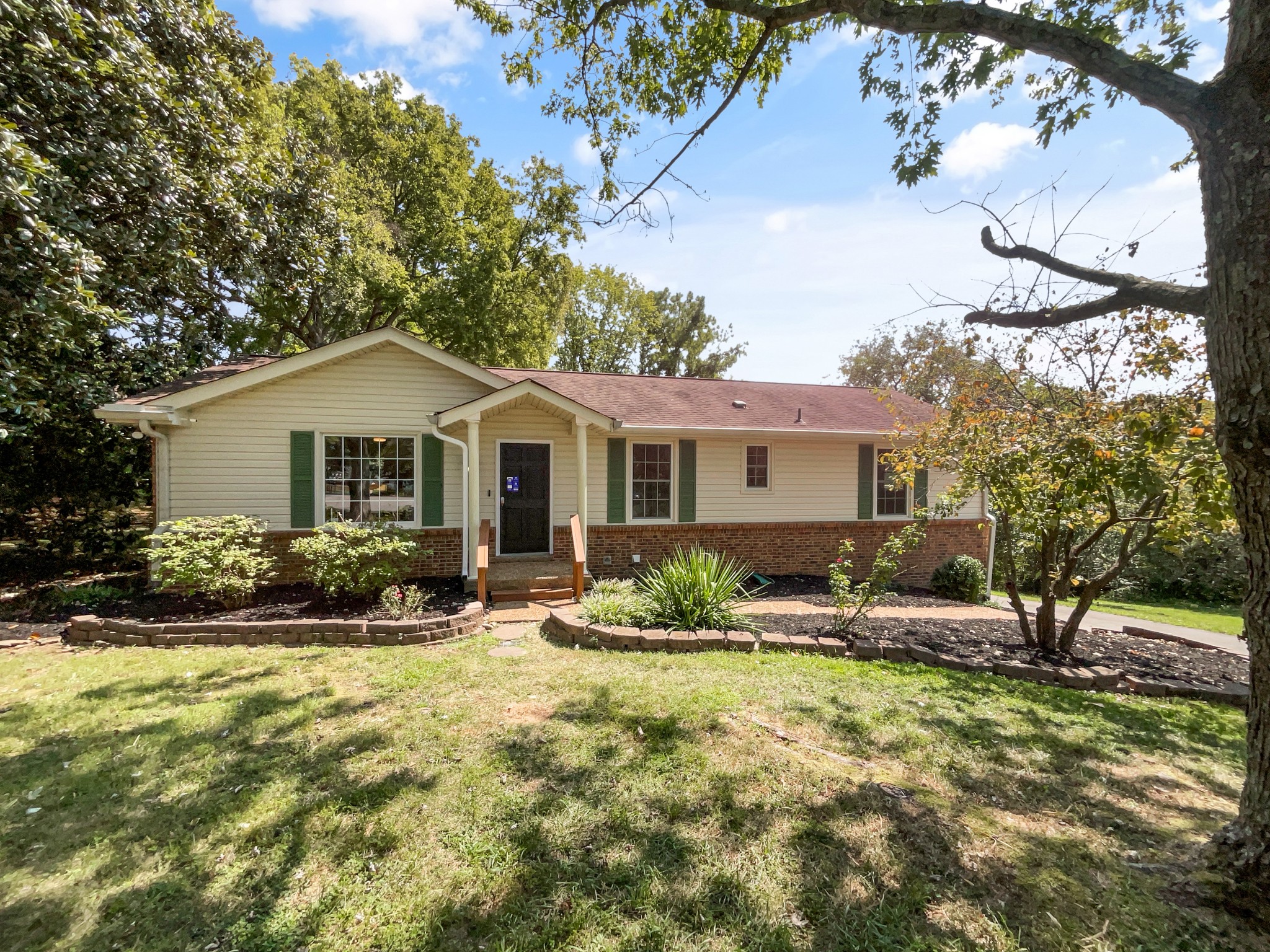 a front view of house with yard outdoor seating and green space