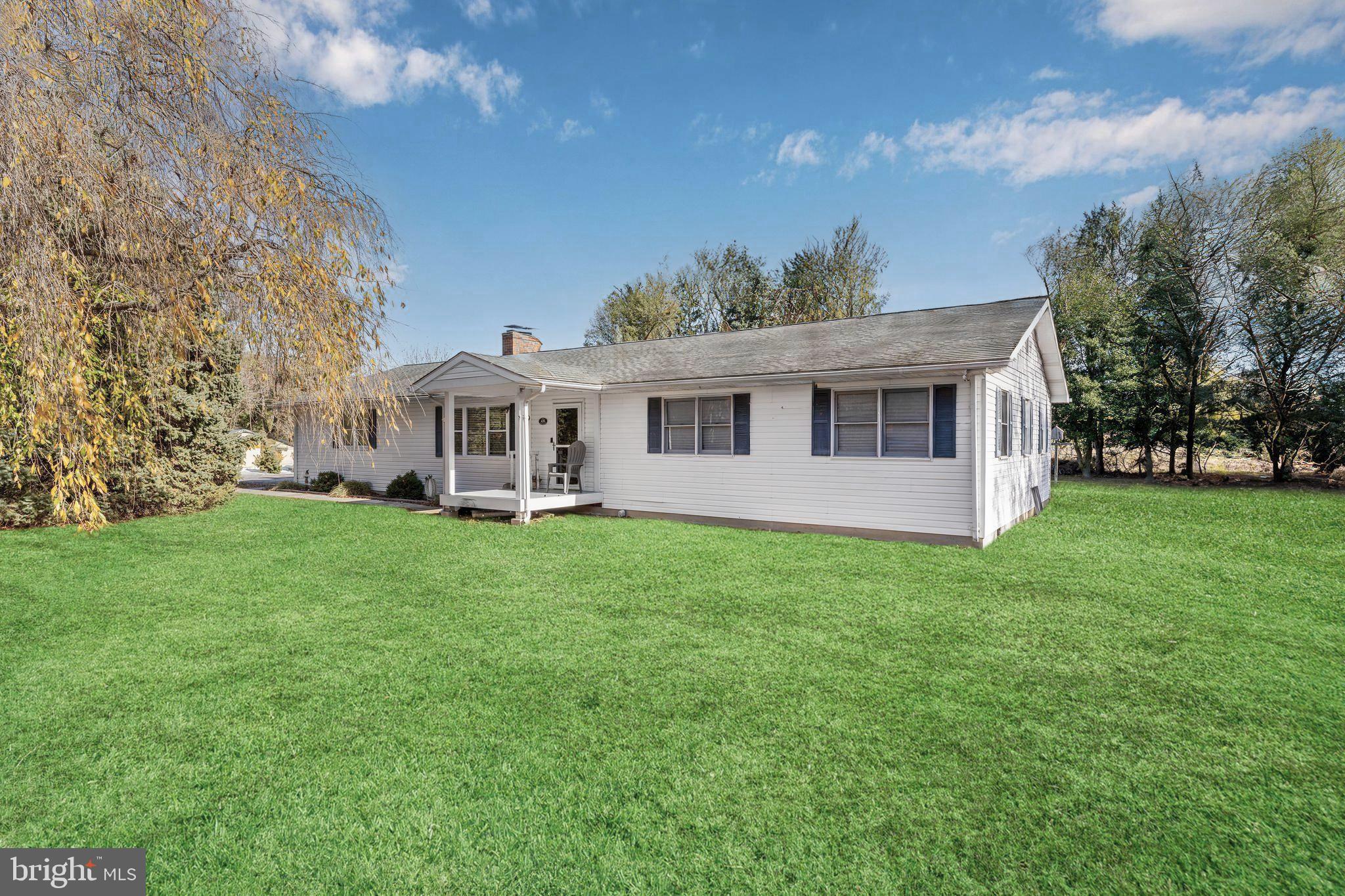 a view of a house with backyard porch and garden