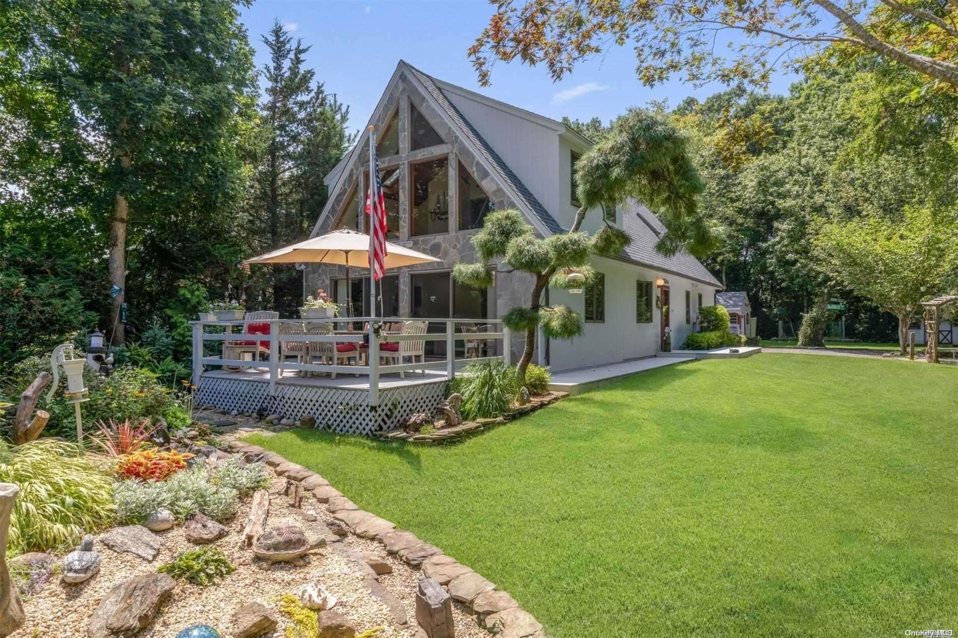 a view of a house with backyard and sitting area