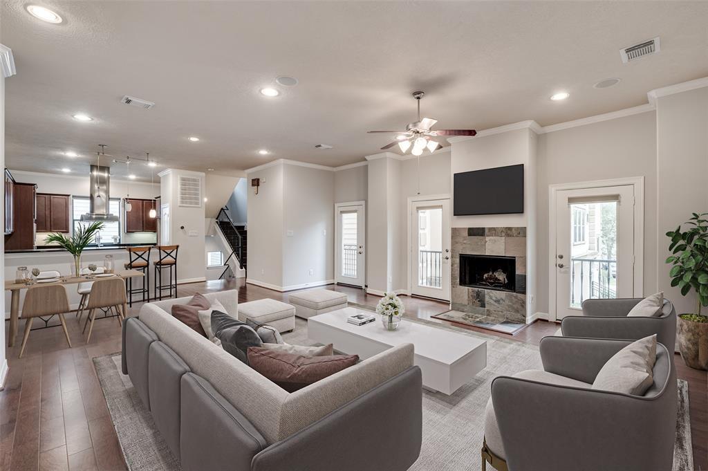 a living room with furniture a fireplace and a flat screen tv