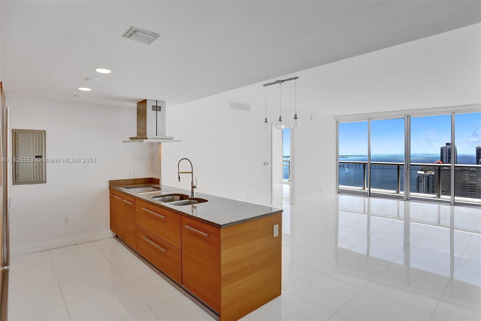 a kitchen with stainless steel appliances granite countertop a sink and a refrigerator