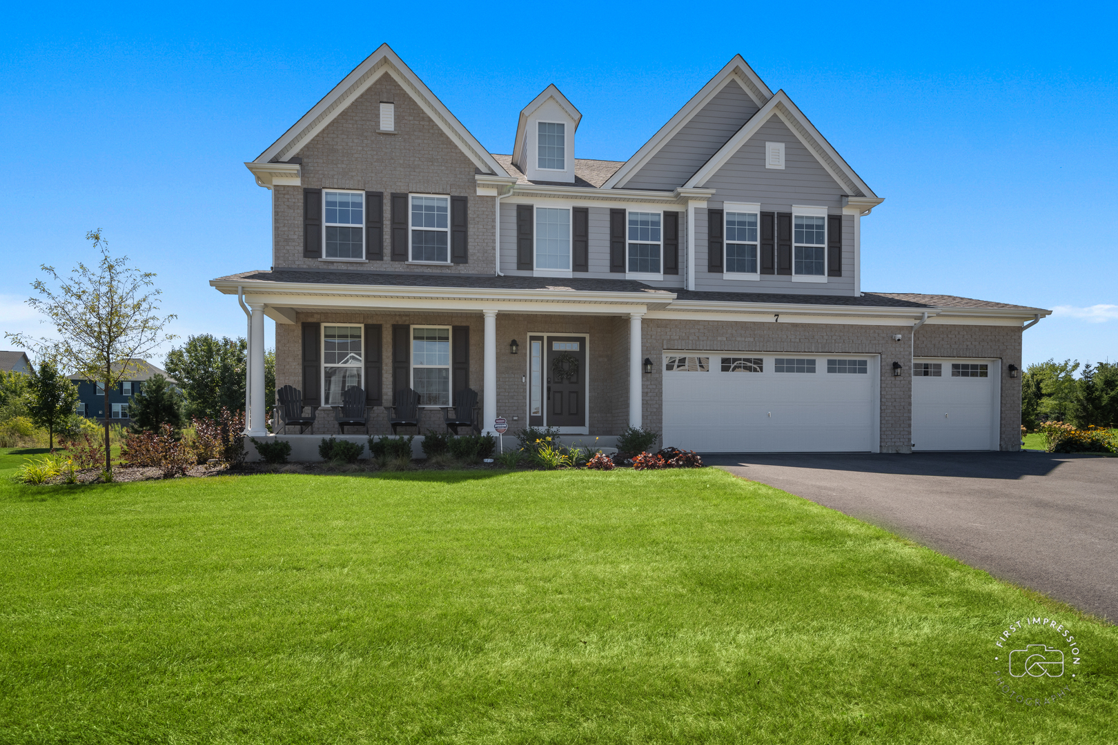 a front view of a house with a yard and garage