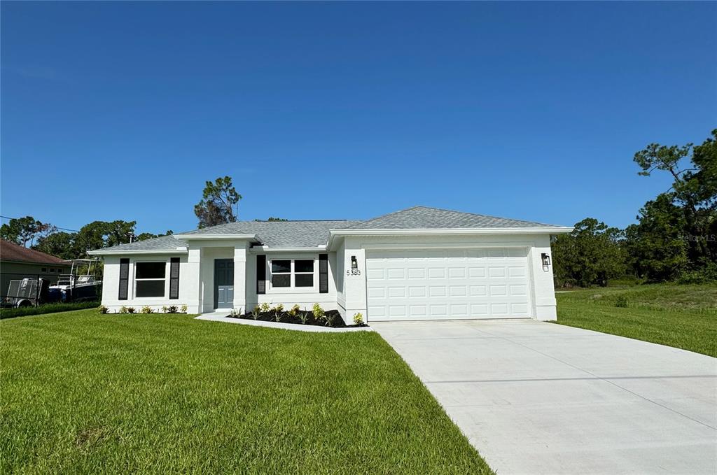 a front view of a house with a yard and garage