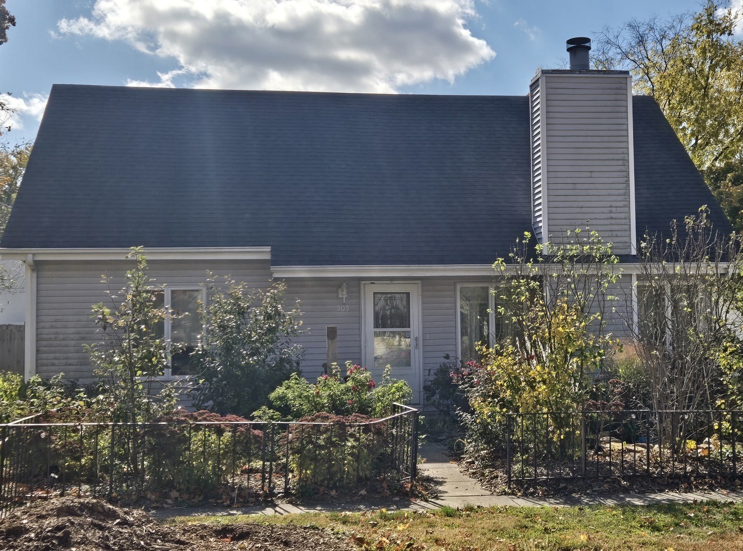 a front view of house and yard with green space