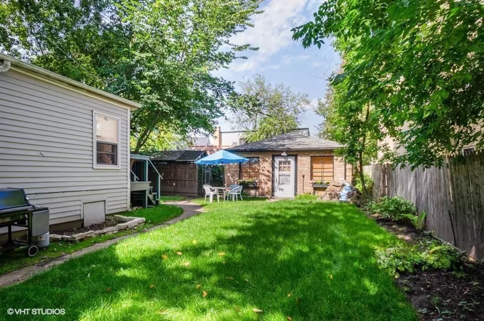 a view of a house with a yard and sitting area