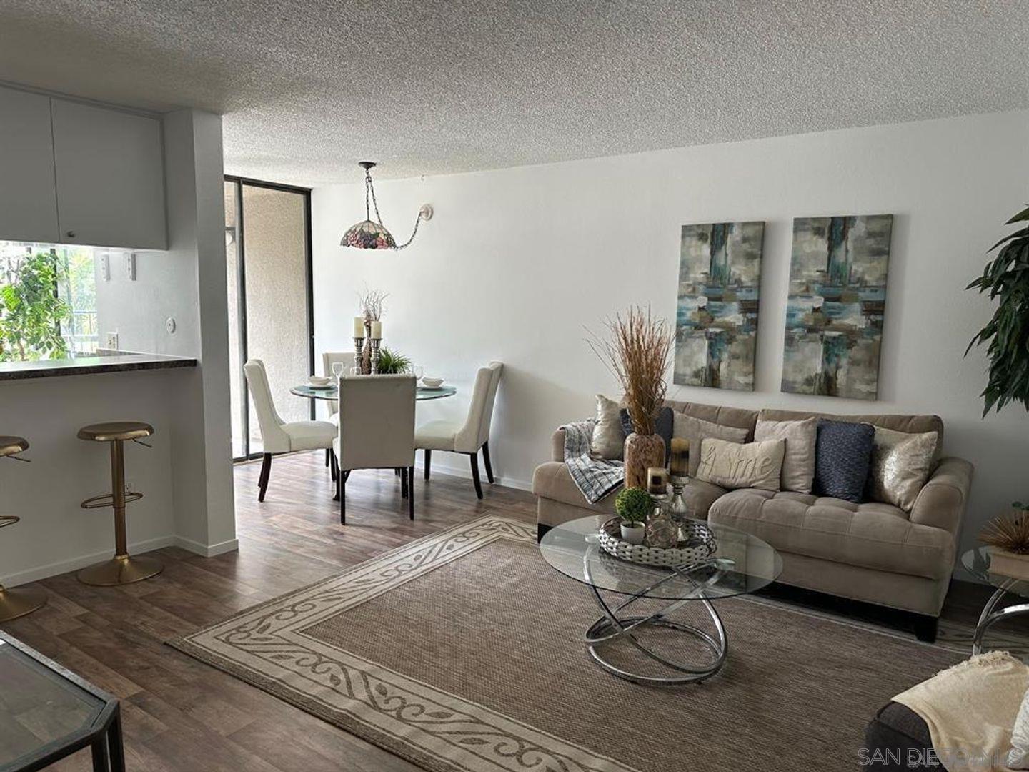 a living room with furniture a dining table and a window