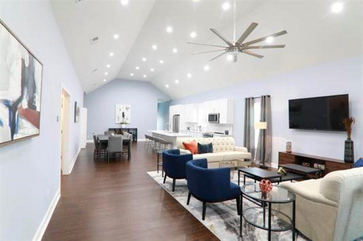 a living room with lots of furniture and a flat screen tv