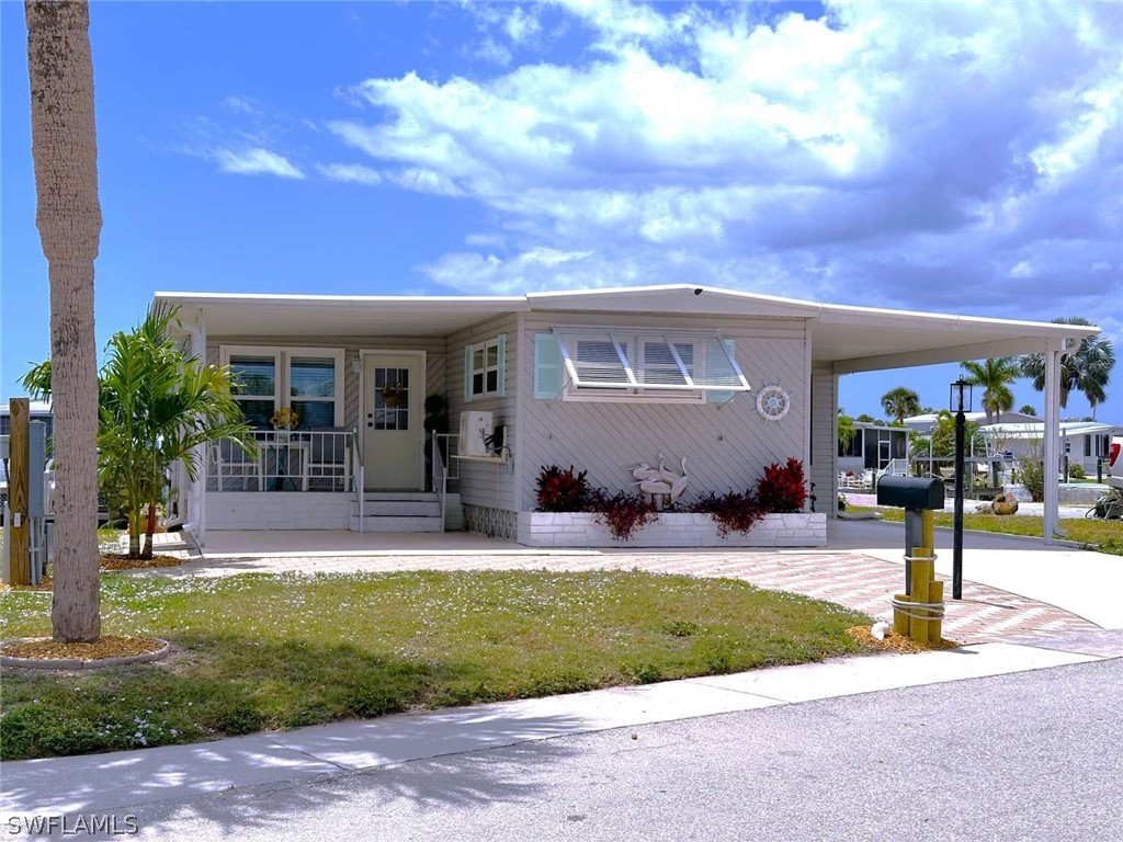 a front view of house with yard and green space