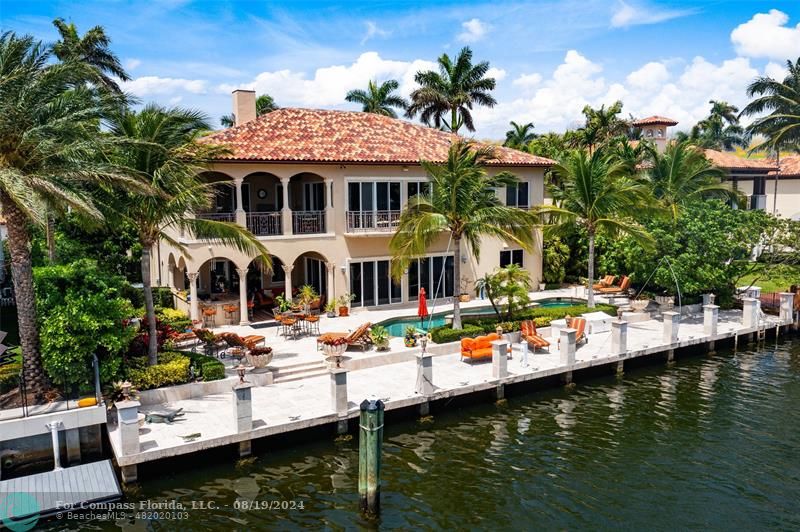 a view of house with swimming pool and a patio