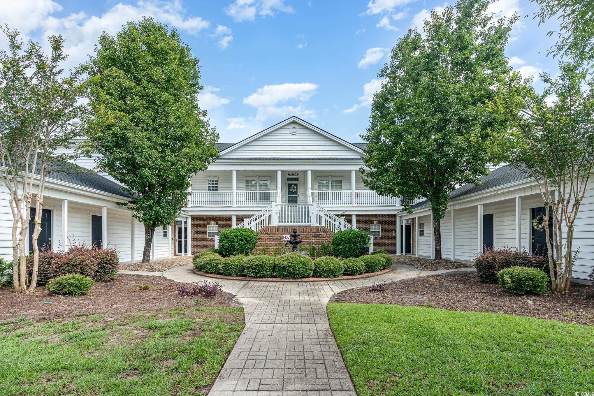 View of front of property with a garage, a front l