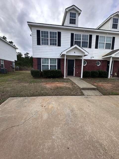 a front view of a house with a yard