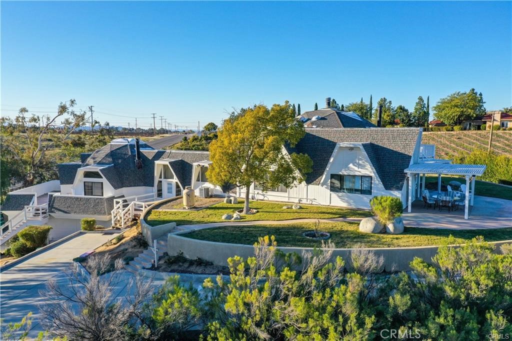 an aerial view of a house with swimming pool garden and patio