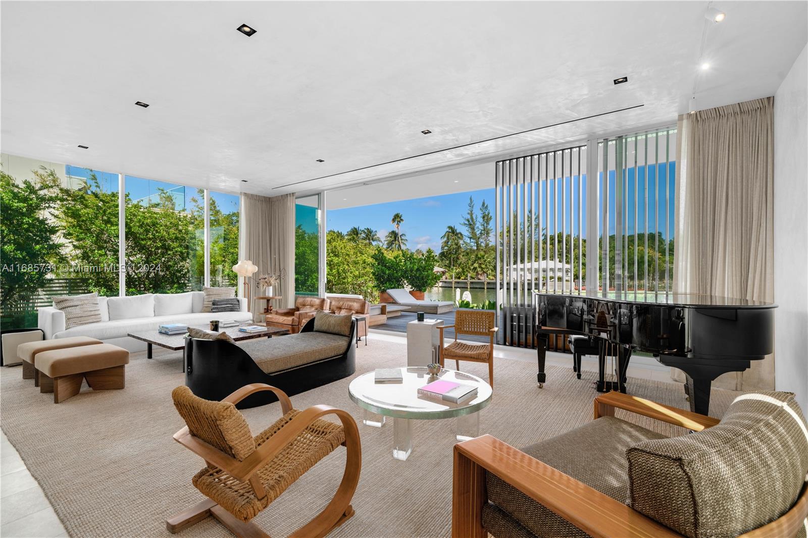 a living room with furniture and large windows