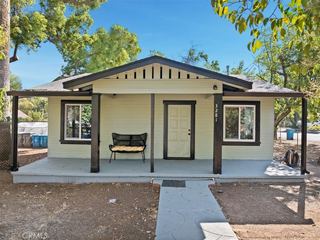 a front view of a house with outdoor seating