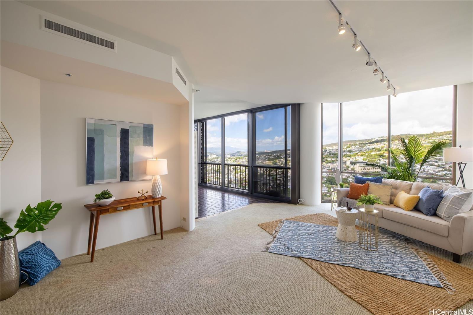 a living room with furniture and a floor to ceiling window