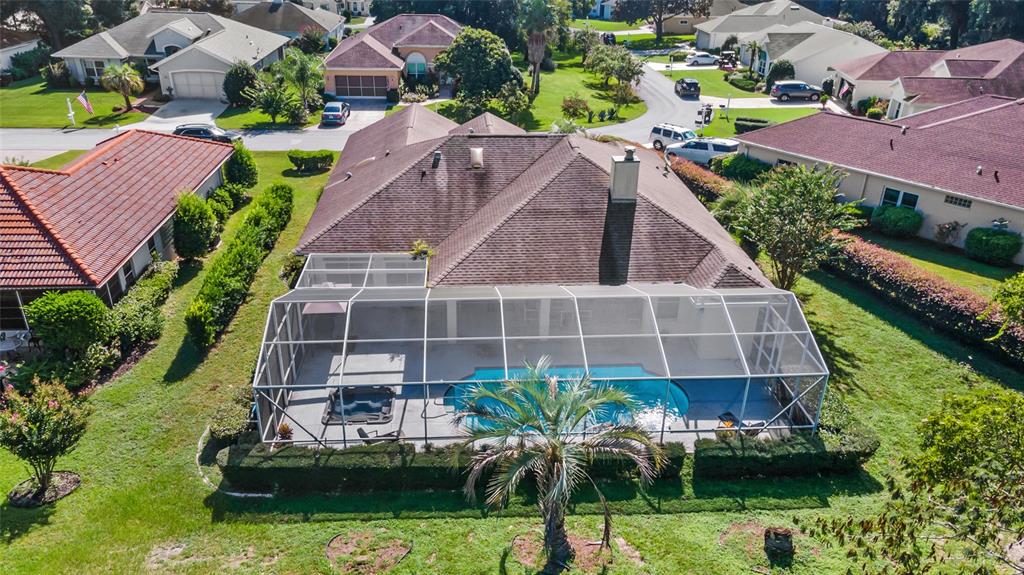 a aerial view of a house with a yard and potted plants