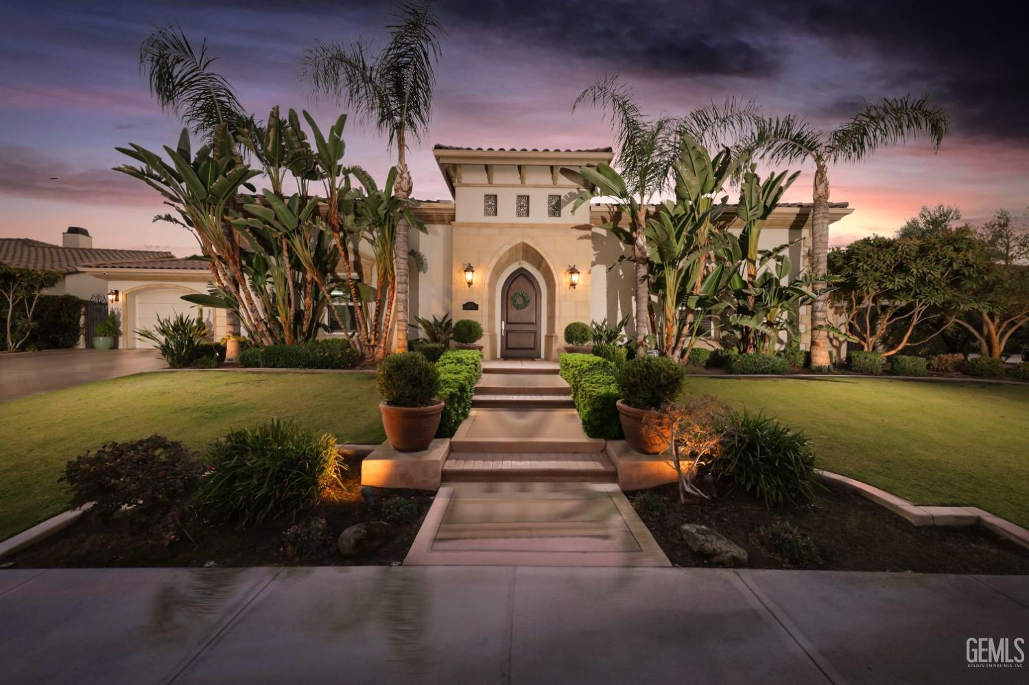 a front view of a house with a garden and yard