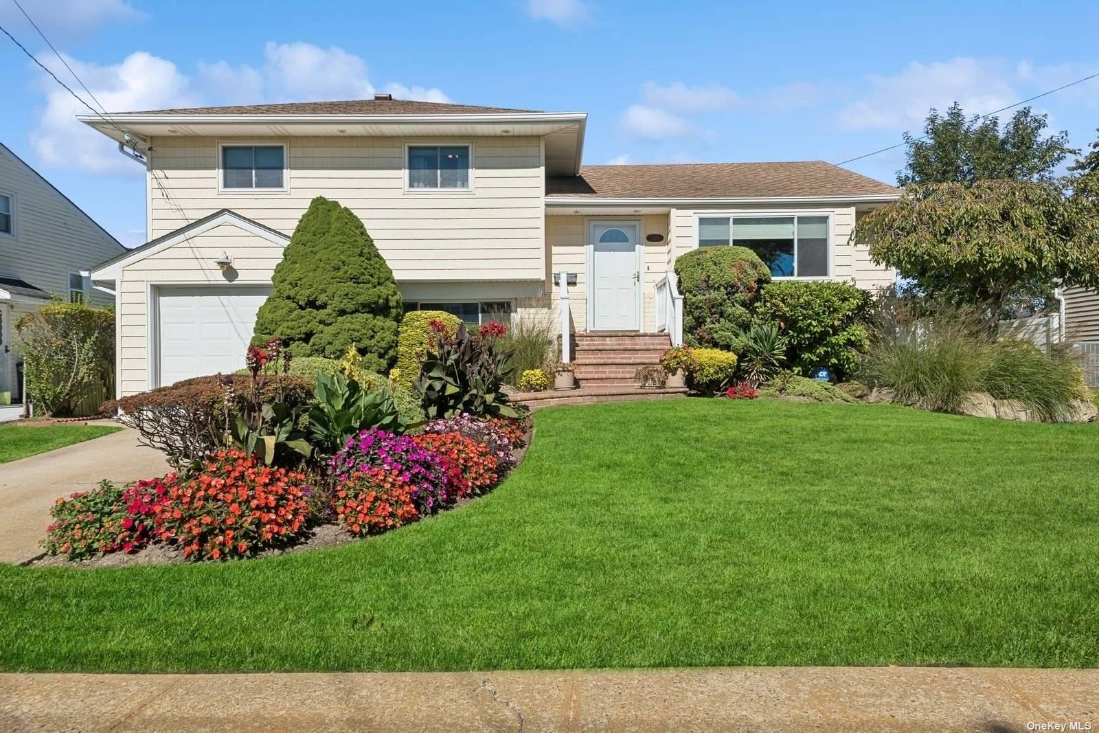 a front view of a house with a garden