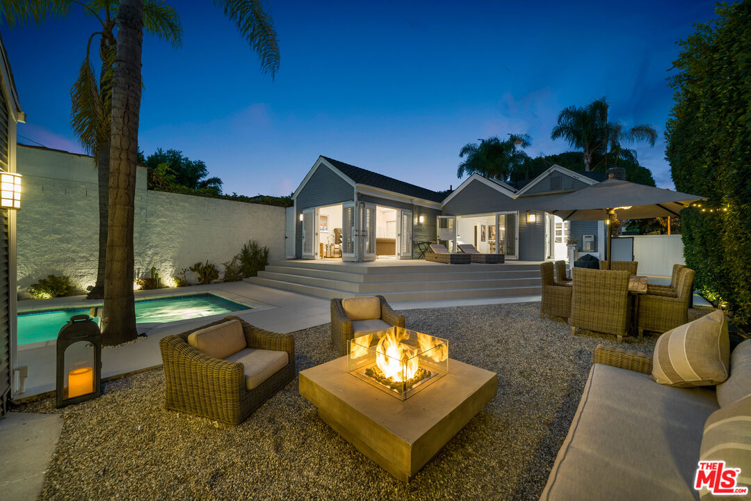 a backyard of a house with table and chairs