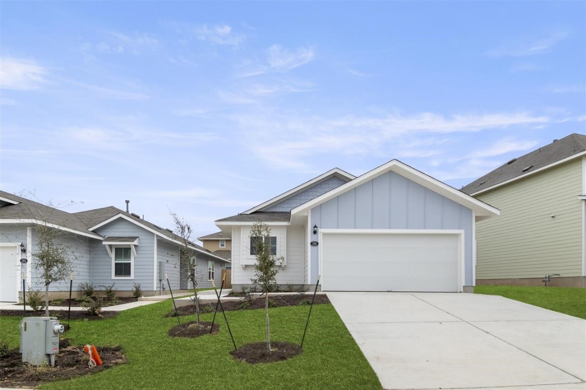 a front view of house with yard and green space