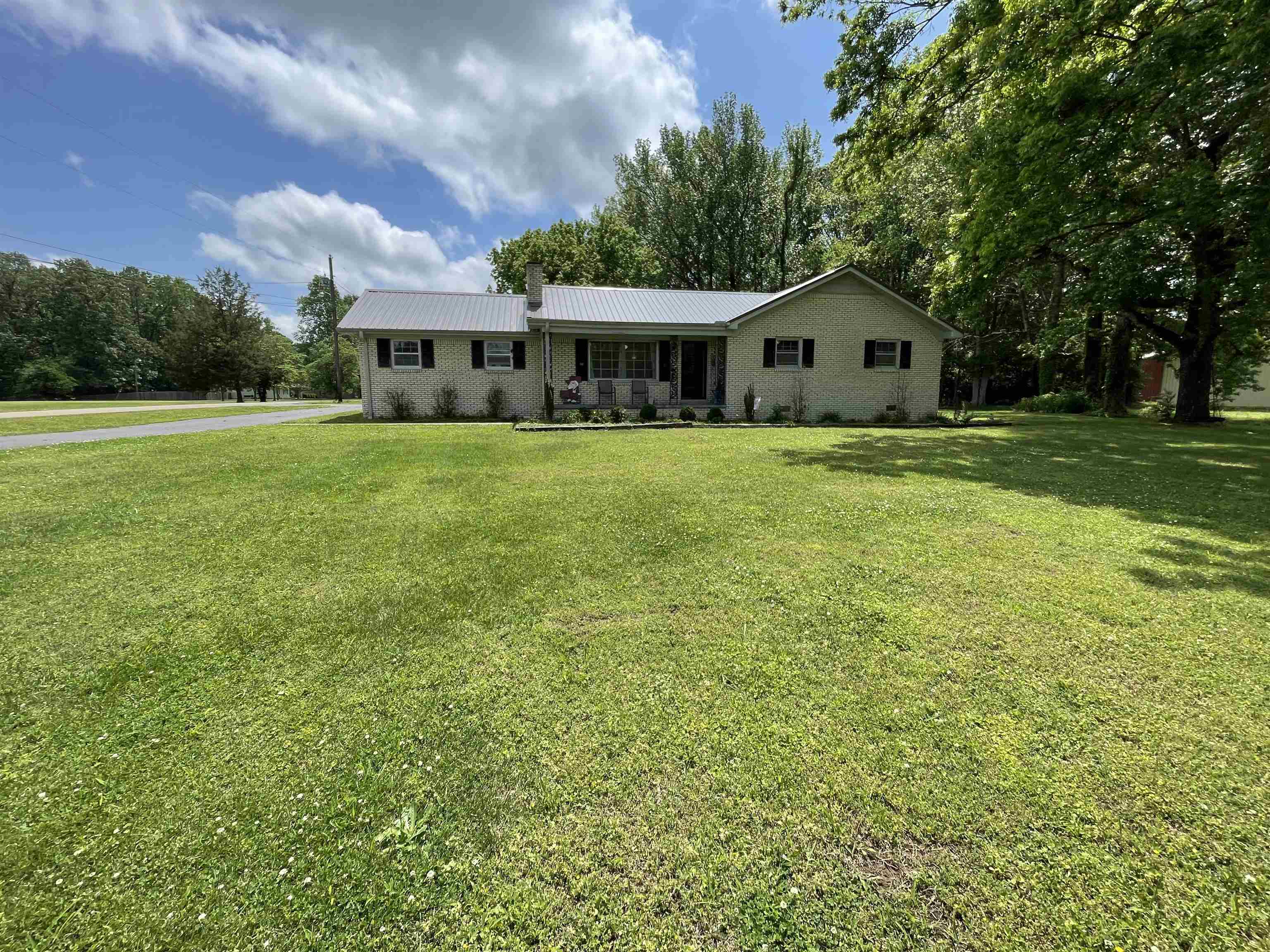 a front view of house with yard and green space