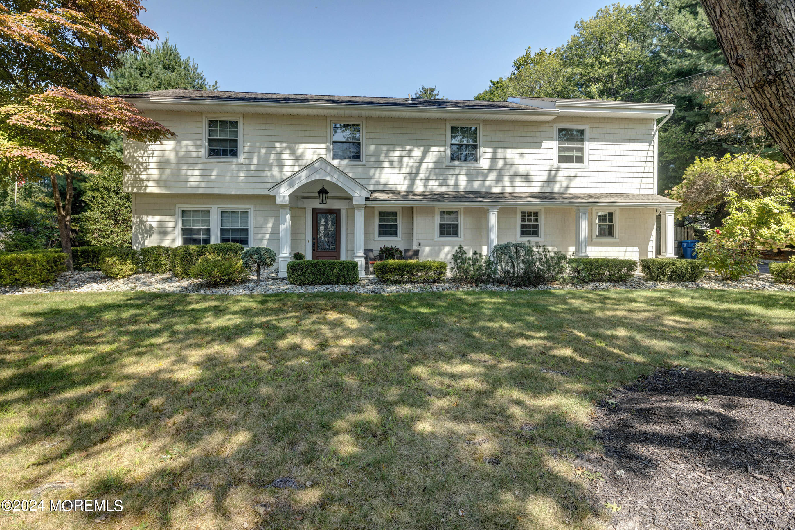 a front view of a house with a garden