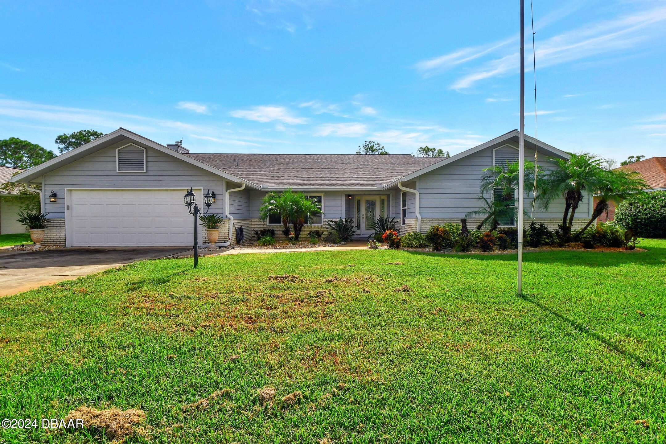 a front view of house with yard and green space