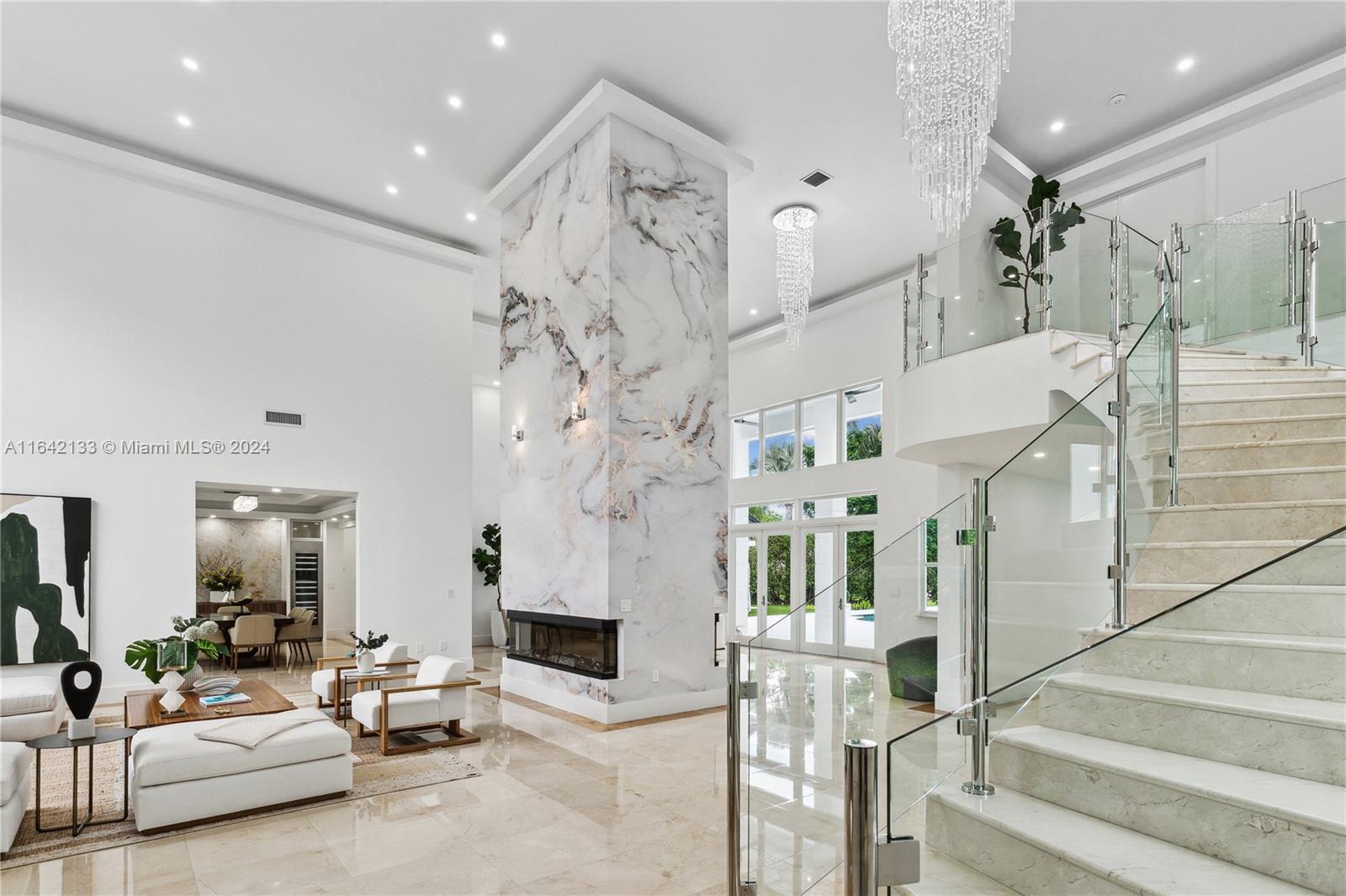 a living room with fireplace furniture and a chandelier