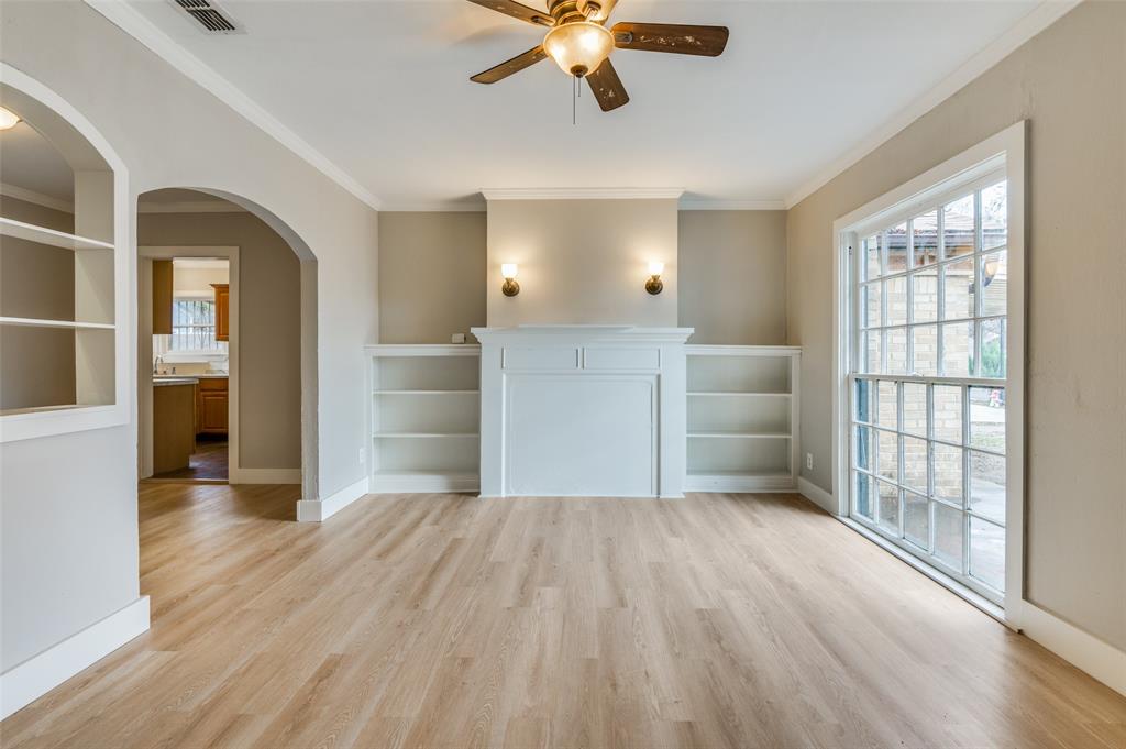 wooden floor in an empty room with a window and wooden floor