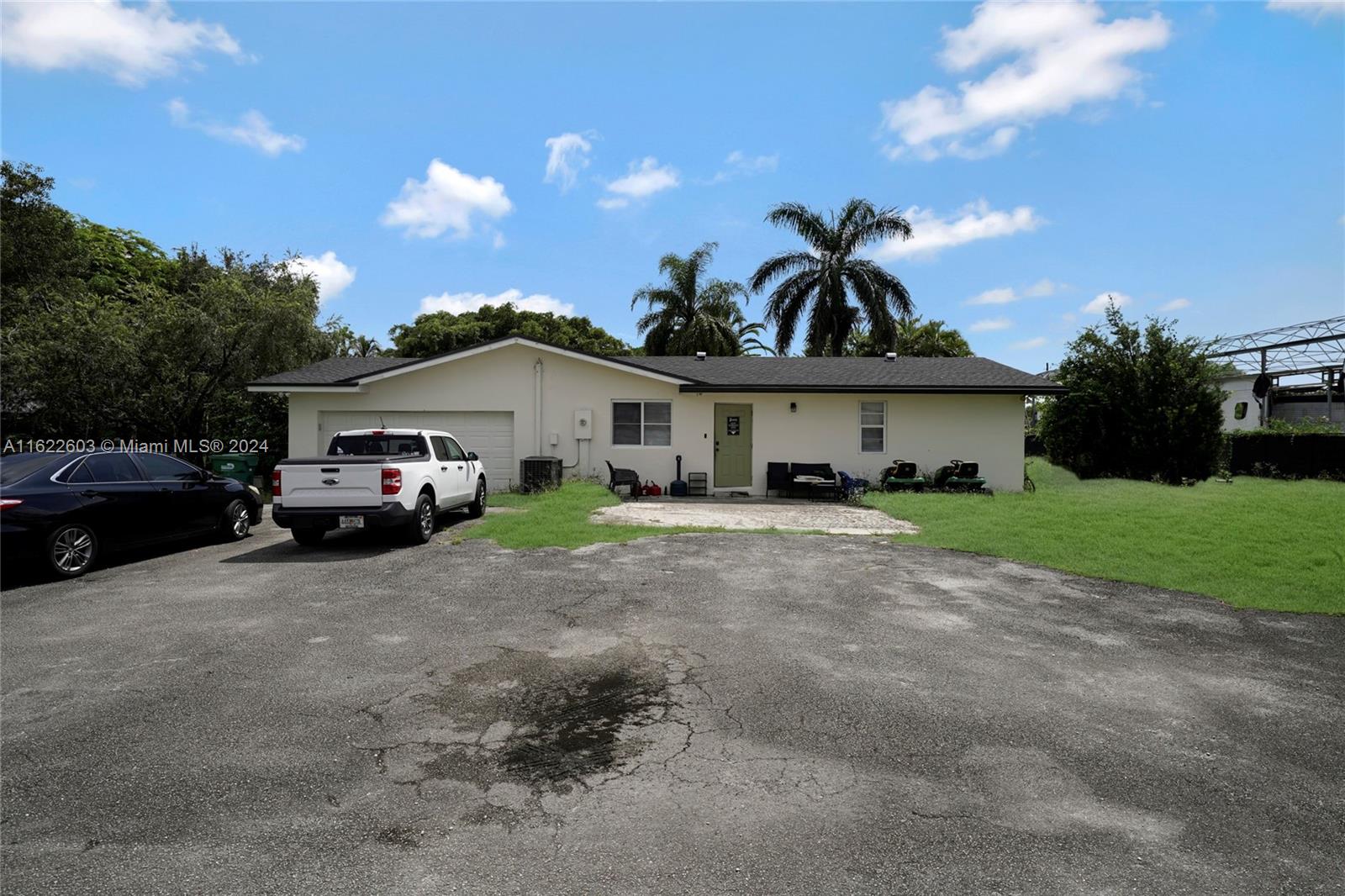 a view of multiple house with cars parked