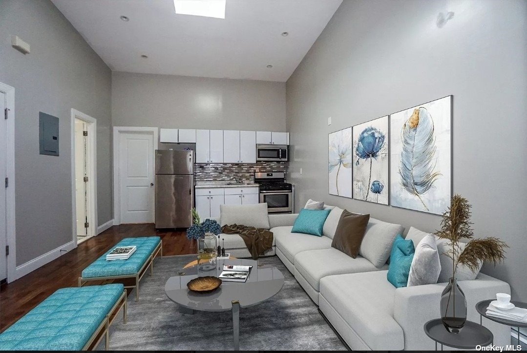 a living room with furniture and kitchen view