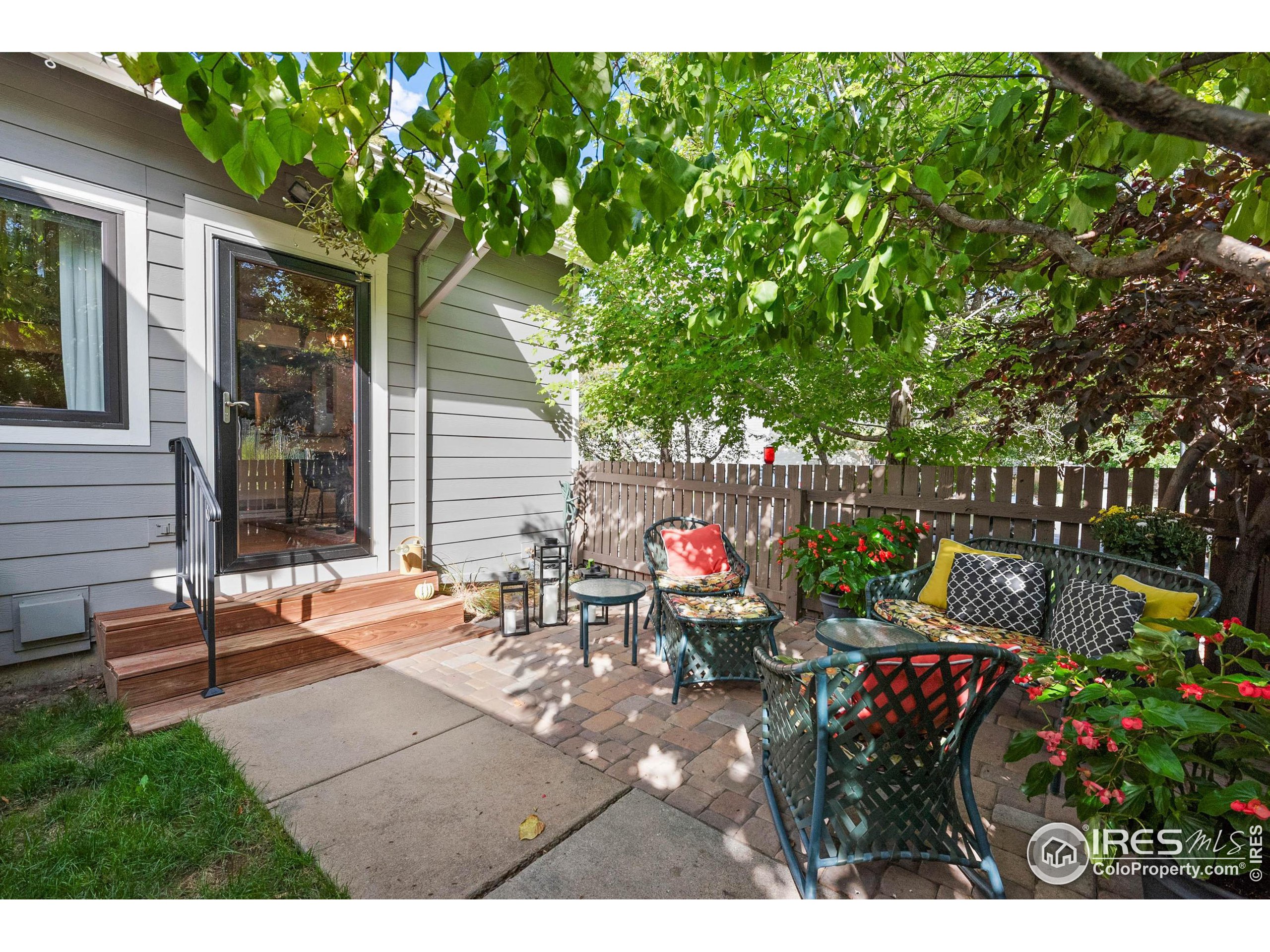 a view of a chairs and tables in the back yard of the house