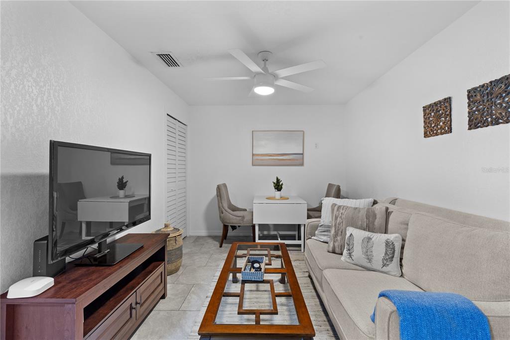 a living room with furniture and a mirror