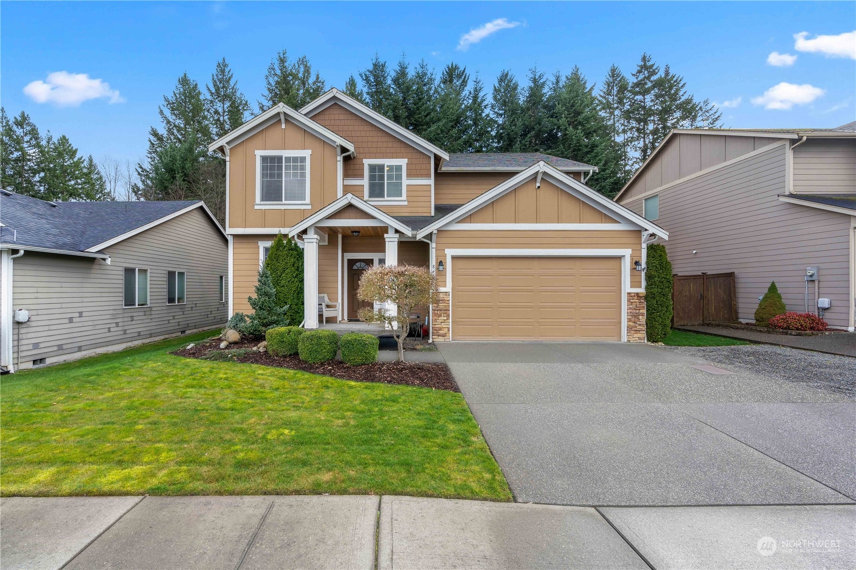 a front view of a house with a yard and garage