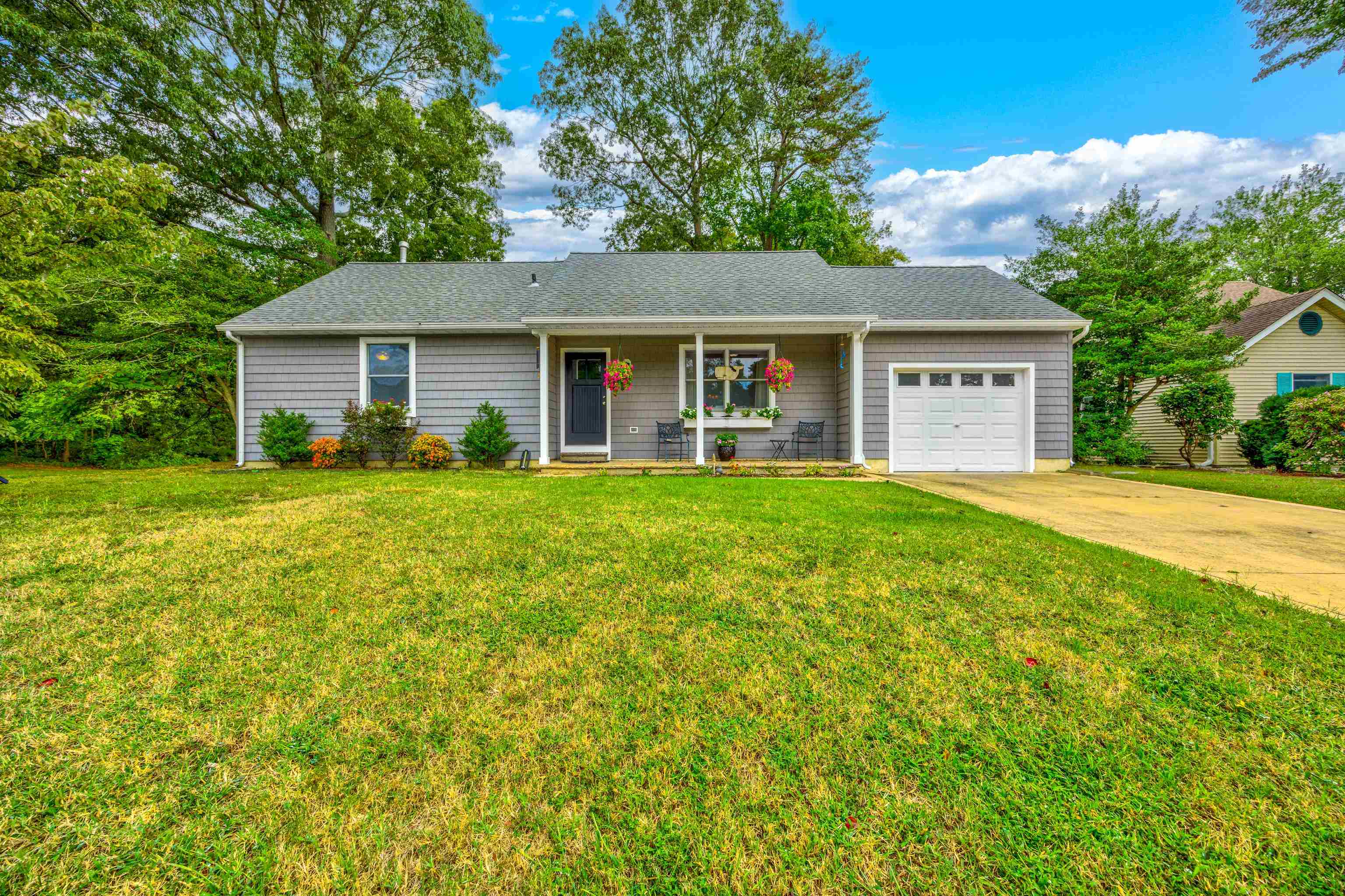 a front view of house with yard and green space