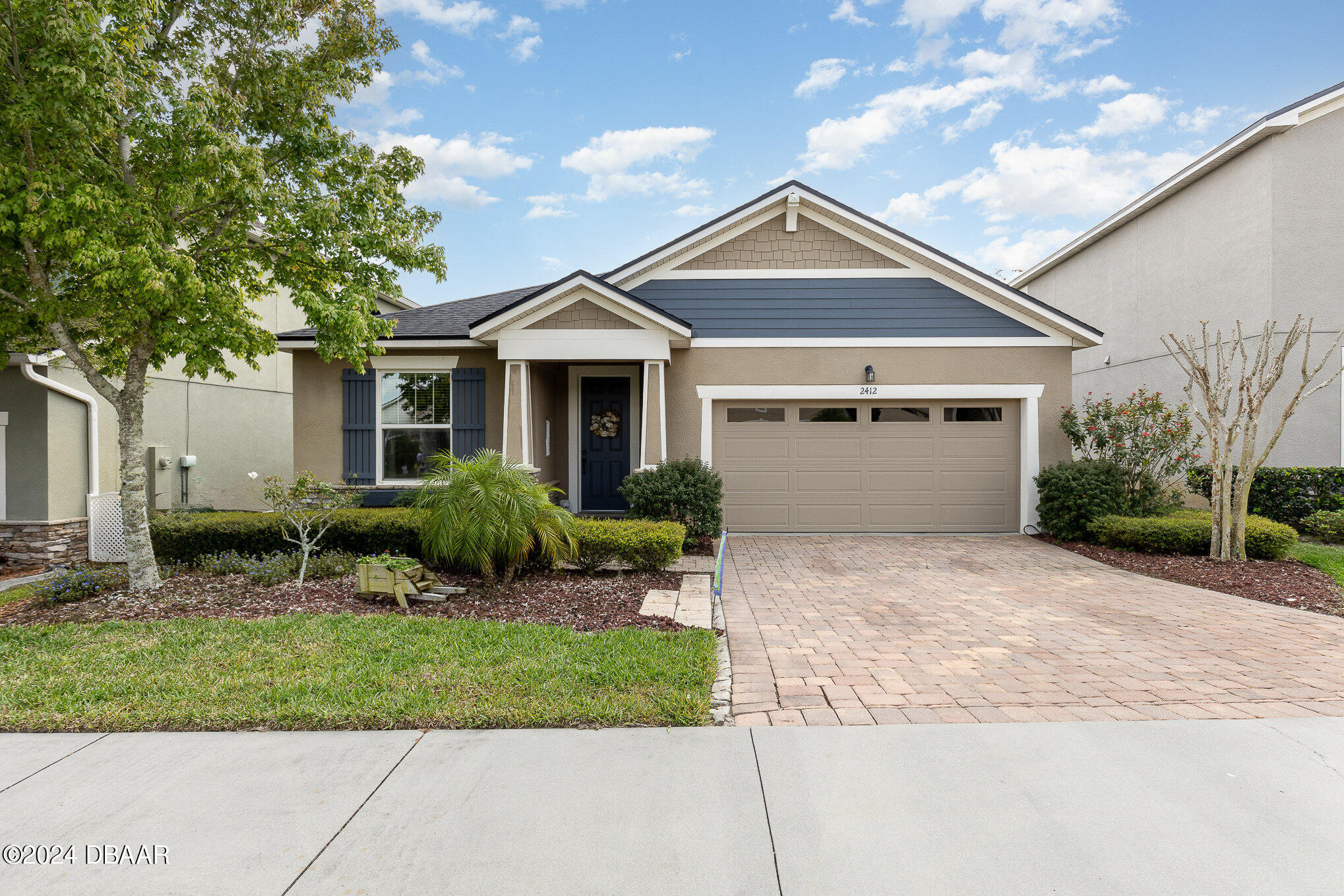 a front view of a house with a yard