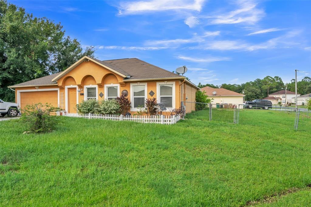 a front view of a house with a garden and yard