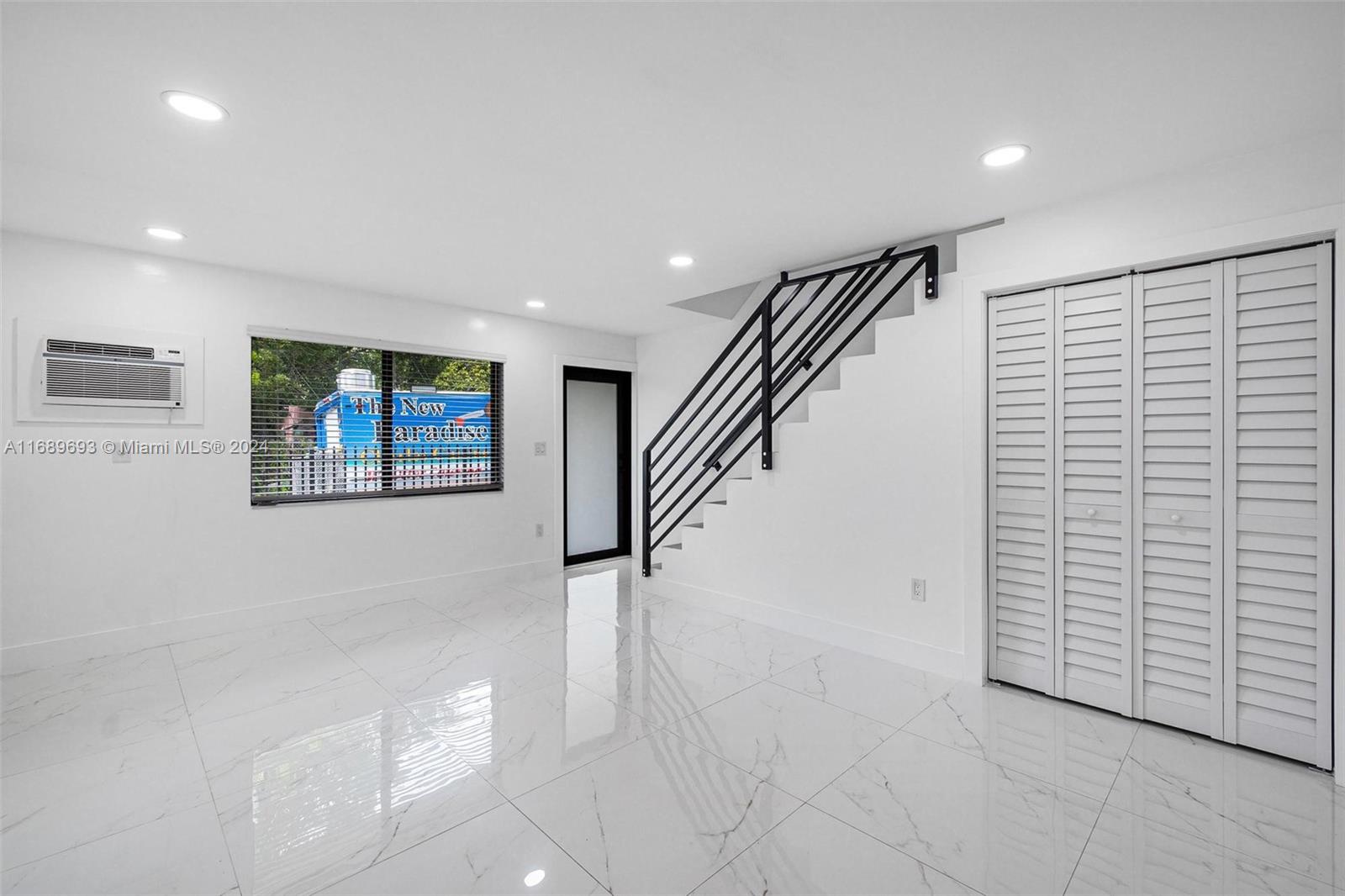 a view of hallway with stairs and a painting on the wall