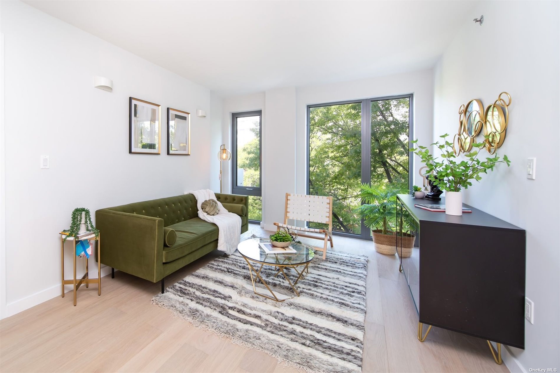 a living room with furniture and a potted plant